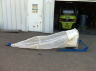 a long conical net laid out on the ground for display
